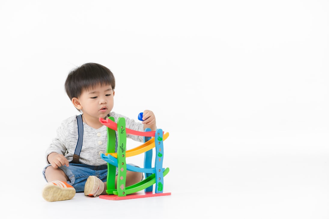 Asian kid playing with toy