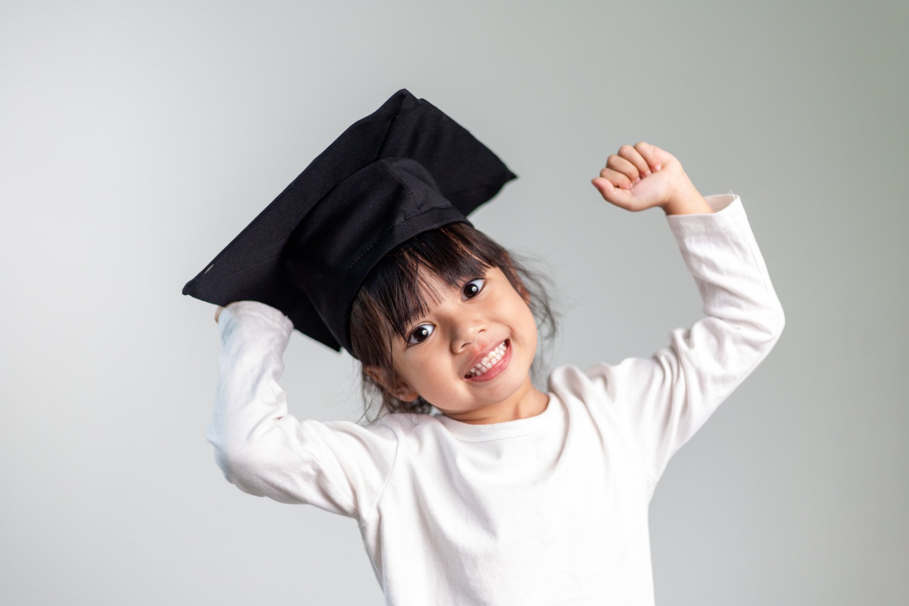 Happy Asian School Kid Graduate in Graduation Cap